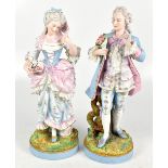 A pair of late 19th century tall bisque figures of a male and female gallant, he is modelled holding