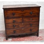 An early 19th century mahogany secrétaire chest, the top drawer with pull-down front enclosing