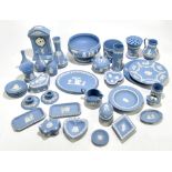 WEDGWOOD; a collection of thirty-nine pieces of blue jasperware including mantel clock, height 23cm,