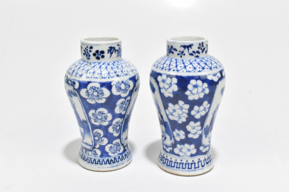 A pair of late 19th century Chinese Kangxi style blue and white vases, decorated with panels of - Image 4 of 6