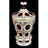 An early 20th century Bohemian flashed glass lidded jar with hand painted floral detail on an opaque