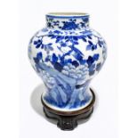 A late 19th century Chinese blue and white porcelain jar decorated with exotic birds perching beside