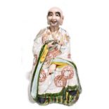 A late 19th century Chinese figure representing a seated scholar wearing a gown with relief and