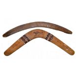 An Australian Aboriginal carved hardwood boomerang, 54cm and a painted and painted and poker work