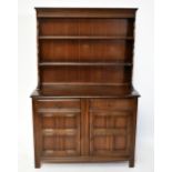A Priory style elm dresser with plate rack back, the back with two shelves above the base section,