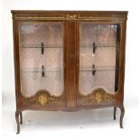 A French walnut and gilt brass mounted two door display cabinet in the manner of Henry Dasson,