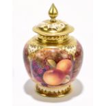 ROYAL WORCESTER; a hand painted pot pourri and cover decorated with fruit inside gilt detail, by J