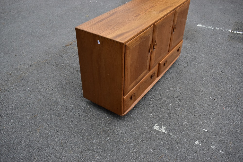 ERCOL; a light elm sideboard, the three panel doors above two base drawers, width 129cm, depth 43cm, - Image 2 of 12