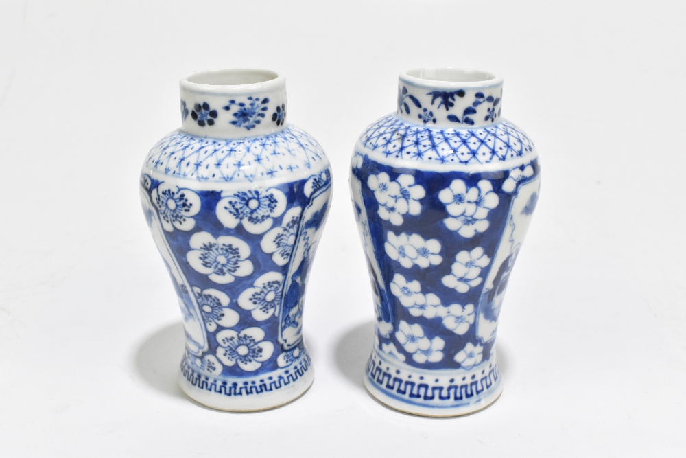 A pair of late 19th century Chinese Kangxi style blue and white vases, decorated with panels of - Image 2 of 6