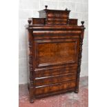 A 19th century French mahogany escritoire, with four carved urn-shaped finials above an