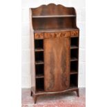 An early 20th century mahogany serpentine fronted cupboard, with three yew wood drawer fronts