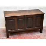 An early 18th century oak coffer with panelled front and pegged brass escutcheon, raised on block