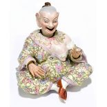 A late 19th century German porcelain nodding head figure modelled as a seated Chinese gentleman