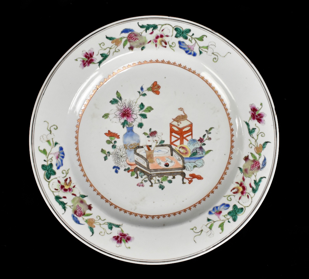 An 18th century Chinese porcelain Famille Rose wall charger decorated with objects to the centre