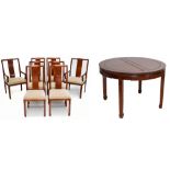 A Chinese hardwood circular extending dining table and eight chairs, the table with two spare leaves