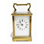 A 19th century French brass cased carriage clock, the enamel dial set with Roman numerals, with swan
