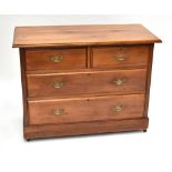 An old varnished pine chest with two short over two long drawers, raised on plinth base, width