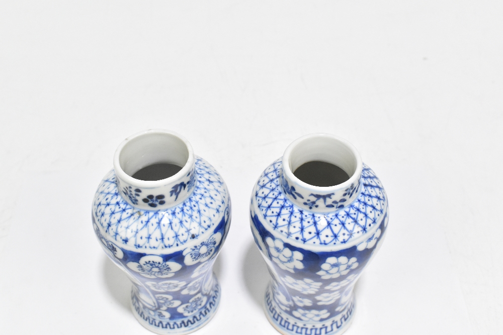 A pair of late 19th century Chinese Kangxi style blue and white vases, decorated with panels of - Image 5 of 6