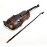 An extremely unusual violin of all wooden construction including inbuilt chin rest, probably a