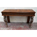 A Regency style walnut console table, with moulded rectangular top above a detailed freize, on two