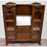 A 1920s/1930s oak side-by-side, bureau bookcase, with four fronts to the centre above two drawers,