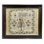 A 19th century needlework sampler by Elizabeth Lomas, decorated with still life and a central