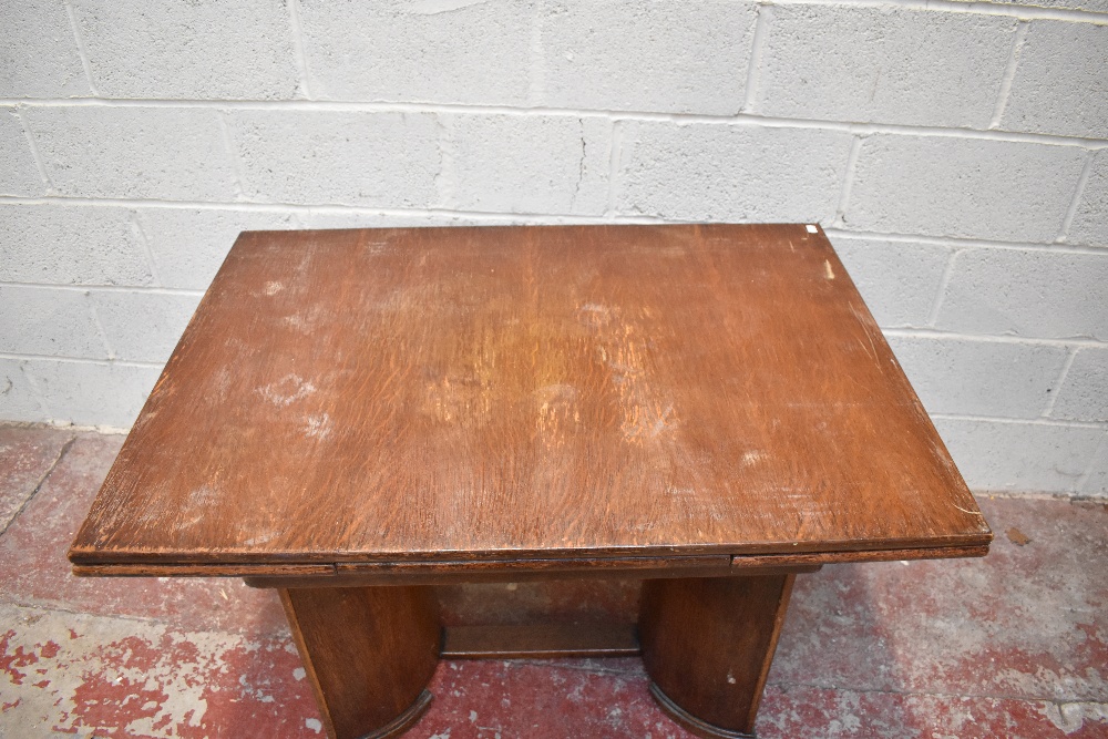 A late Art Deco oak extending dining table and four chairs, the rectangular table with two pull - Image 3 of 5