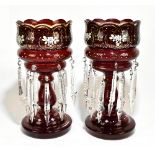 A pair of late Victorian ruby coloured glass table lustres, with enamelled floral decoration and