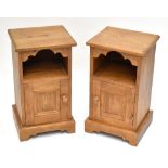 A pair of modern pine bedside cabinets, each with storage compartment above single cupboard door