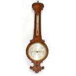 J L CASARTELLI; a 19th century burr walnut banjo barometer of large proportions, with silvered dial,