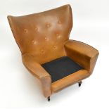 G-PLAN; a mid-century swivel reclining armchair upholstered in a vinyl button back material,