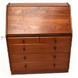 NATHAN FURNITURE; a teak bureau, with fall above four graduated long drawers, the upper drawer