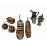 Two 1950s African carved wood tribal masks, height of largest 60cm, together with two boat