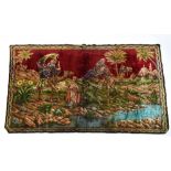 A camel fur tapestry wall hanging, decorated with Arabs on camels beside temple and lake scene,