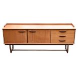 G-PLAN; a Fresco range teak sideboard, with two cupboard doors and three drawers, on shaped end