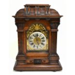 An early 20th century German elm and beech mantel clock, the brass face with applied chapter ring