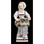 MEISSEN; a late 19th century hard paste porcelain figure representing a girl carrying a basket of