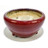 A Chinese sang de boeuf bowl with three relief balls, height 11cm, diameter 21cm.Additional