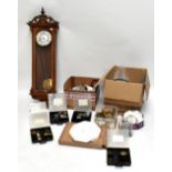 An assortment of clock restorers' items including drums, movements, keys, sections, and a walnut