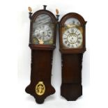 Two Continental wall clock cases, each with a domed hood and decorated dial, one in an oak case