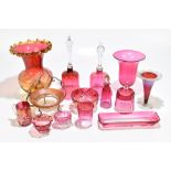 A collection of Victorian and later cranberry glassware including two bells, trumpet vase, etc.