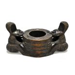 NEW ZEALAND; a Maori carved wood bowl or inkwell, modelled with two Tiki with inset mother of