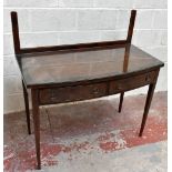 An Edwardian inlaid mahogany bowfront sideboard with inset glass back panel above an arrangement