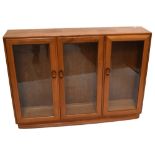 ERCOL; an elm three door display cabinet, height 97cm, width 136cm, depth 28.5cm.