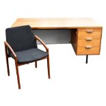 ROBIN DAY; a mid century Hille teak desk with white Formica back panel, with an arrangement of three