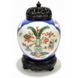 A late 19th century Chinese Famille Verte Wucai porcelain ginger jar with associated carved wooden