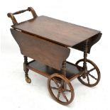 A reproduction oak two tier drinks trolley, height 73cm, length 89cm.