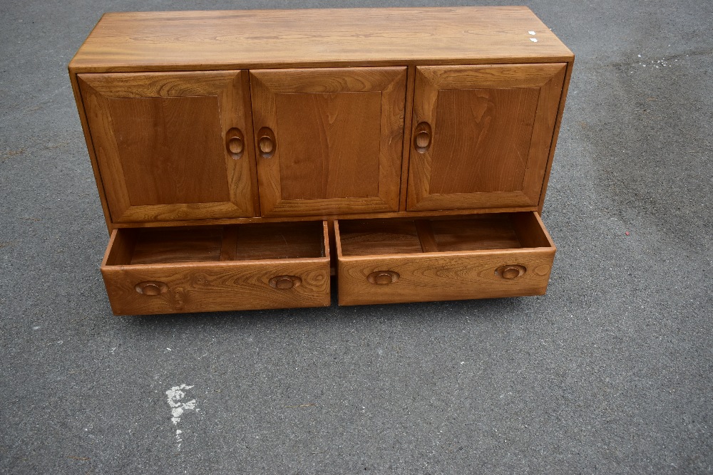 ERCOL; a light elm sideboard, the three panel doors above two base drawers, width 129cm, depth 43cm, - Image 10 of 12