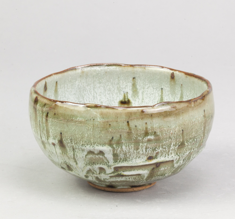 ALEX SHIMWELL (born 1980); a small stoneware bowl with irregular rim covered in dolomite glaze,