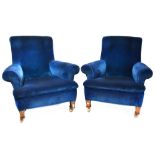 A pair of early 20th century oak framed armchairs with scrolling backs,